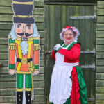 Mother Christmas standing next to a nutcracker